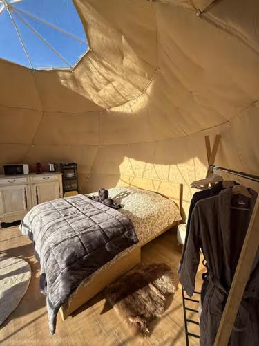 a bedroom with a bed in a tent at Le dôme de Jèpo in Ilonse