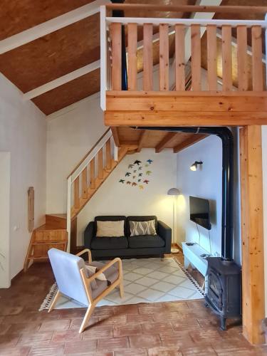 a living room with a couch and a staircase at Alba Odeceixe - casa blanca in Odeceixe