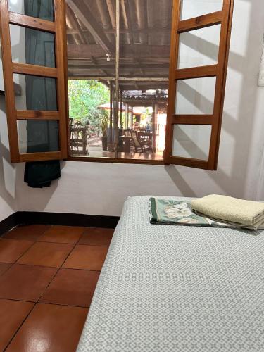 a bed sitting in a room with a window at Casa de Los Berrios in León