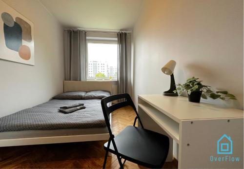 a small bedroom with a bed and a desk at Funky Room - 5 Minutes to Sopot Molo & Seaside in Sopot