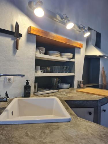 a kitchen with a sink and a counter top at Alba Odeceixe - casa blanca in Odeceixe