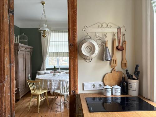 a kitchen with a table and a dining room at Vēsturiska privātmāja Ogres centrā in Ogre