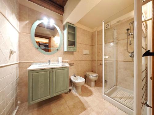 a bathroom with a toilet and a sink and a shower at Hostdomus - Flower Loft in Cesana Torinese