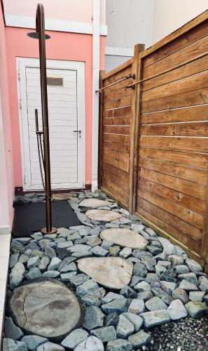 a fence with a door and a stone walkway at Malora Beach in Le Moule