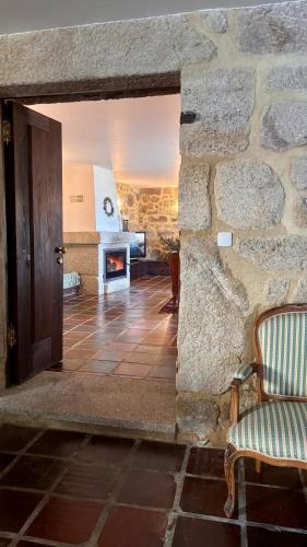 a room with a stone wall with a door and a fireplace at The Hideaway at Quinta de Moçamedes - Suites & Apartments in Vouzela