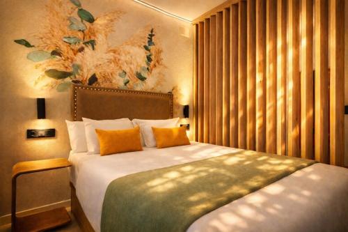 a bedroom with a large bed with orange pillows at DozZze Julieta in Alicante