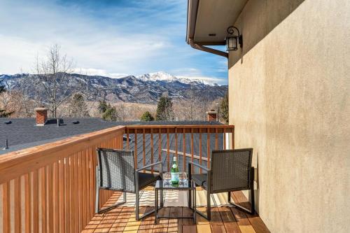 a patio with two chairs and a table on a balcony at Urban Float in Colorado Springs