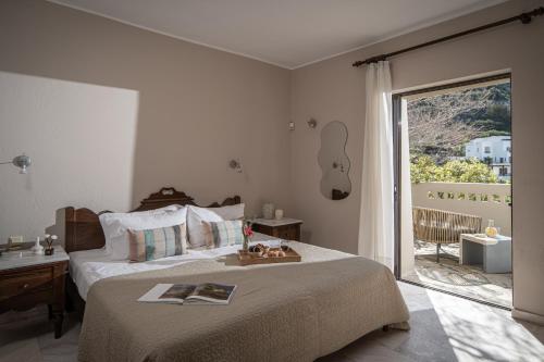 a bedroom with a bed with a guitar on the wall at Istron Luxury Villas in Istro