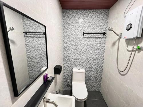 a bathroom with a toilet and a sink and a shower at AURELIA Stay in Brinchang