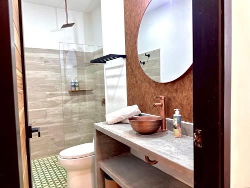 a bathroom with a sink and a toilet and a mirror at La Brisa Loca Prime in Santa Marta