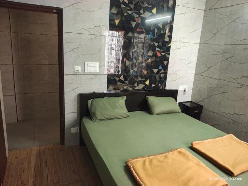 a bedroom with a green bed and a shower at Sri Madapallii in Tiruchirappalli