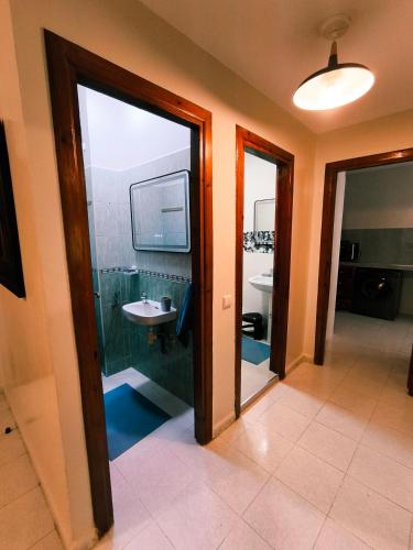 a bathroom with a sink and a mirror at Chez Atlas in Kenitra