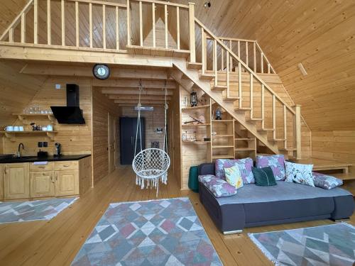 a living room with a couch and a staircase at Aframe in Skhidnitsa