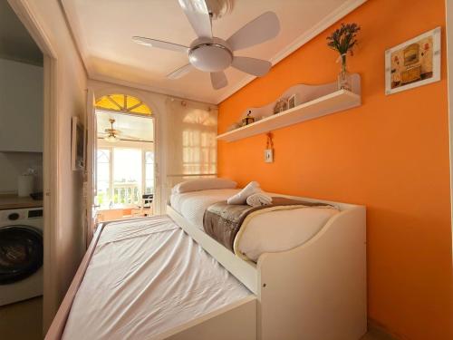 a bedroom with two bunk beds and an orange wall at Beach House Victoria - Beachside - Playa Rincón in Rincón de la Victoria