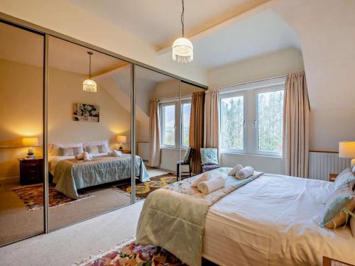 a bedroom with two beds and a large mirror at 3 Bed in Keswick oc-sz135 in Threlkeld