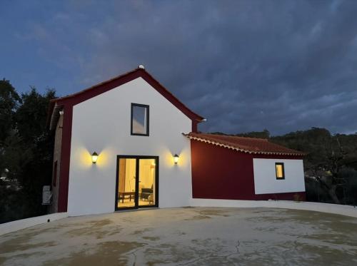 a large white house with a red roof at AlcaidariaVista in Ourém