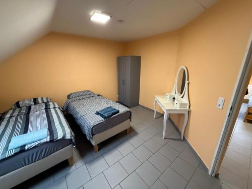 a bedroom with two beds and a mirror at Duren Bahnhof in Düren - Eifel