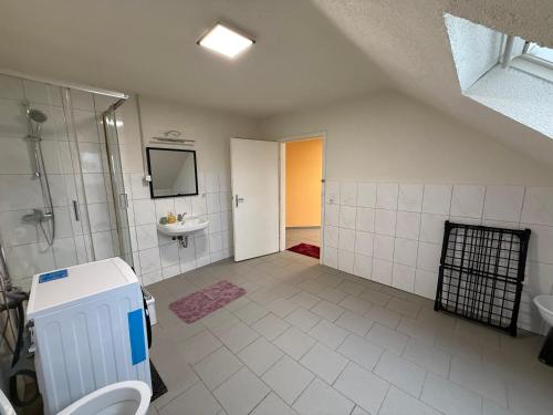 a bathroom with a shower and a sink and a toilet at Duren Bahnhof in Düren - Eifel