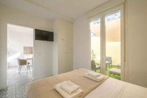 a bedroom with a bed with two towels on it at Marvellous Apt with a Large Private Terrace in Valencia