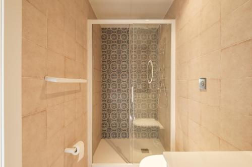 a shower with a glass door in a bathroom at Marvellous Apt with a Large Private Terrace in Valencia