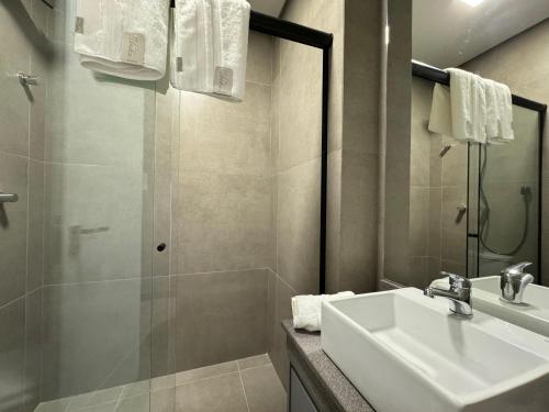 a bathroom with a sink and a shower at Livin517 in Xangri-lá