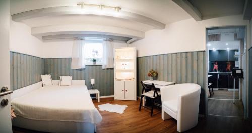 a bedroom with a bed and a desk and a table at Ferienwohnung Gierschner in Kronach