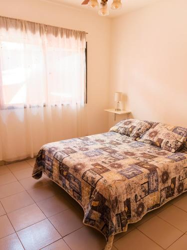 a bedroom with a bed and a window at Olivos Stay in Olivos