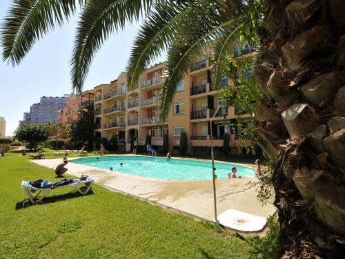 a swimming pool in front of a building at Apartment in Empuriabrava by the Beach in Empuriabrava