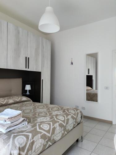 a bedroom with a bed and a mirror at Cavour3 in Nettuno