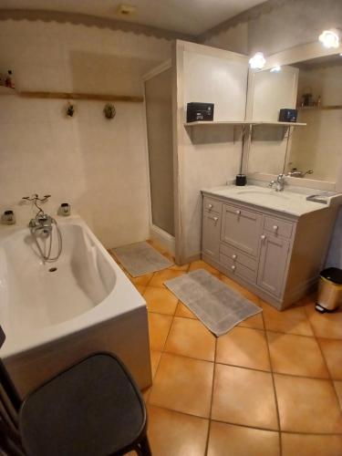 a bathroom with a tub and a sink and a mirror at Alby in Alby