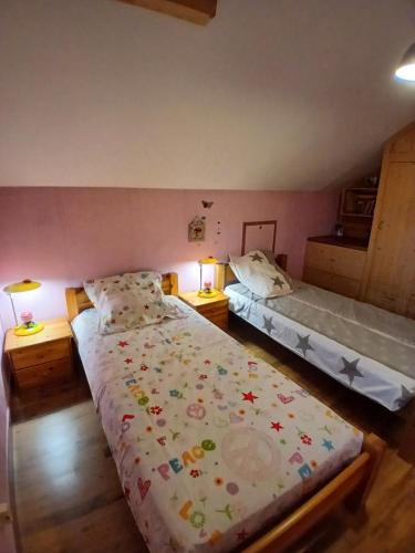 a bedroom with two beds and two lamps in it at Alby in Alby