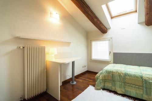 a bedroom with a desk and a bed and a window at Residence La Mason in Montebello Vicentino