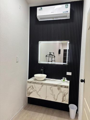 a bathroom with a sink and a mirror at Borunda Suites in General Trías