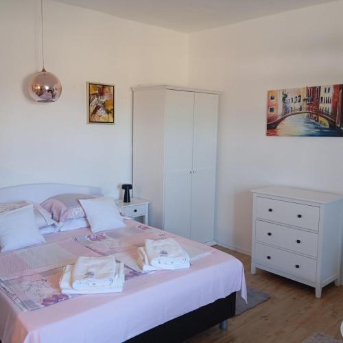 a bedroom with a bed with two towels on it at Anći in Sumartin