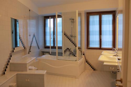a bathroom with a tub and a sink and a bath tub at Villa Manuela-Lake View in Brenzone sul Garda