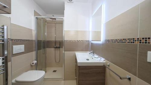 a bathroom with a toilet and a sink and a shower at Hostdomus - La Tana della Volpe in Sauze d'Oulx