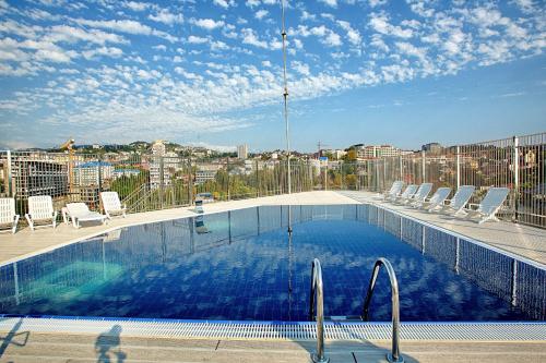 a swimming pool on the roof of a building at Sonata Hotel in Sochi