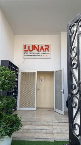a front door of a store with a sign on it at Oasis Villa Stay by Lunar in Abu Dhabi