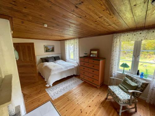 a bedroom with a bed and a wooden ceiling at Haus Paula in Sjötorp