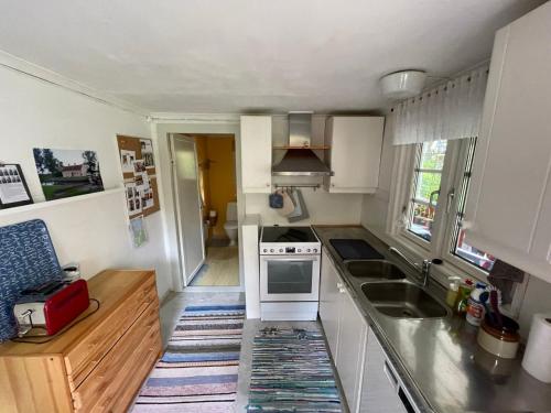 a small kitchen with a sink and a stove at Haus Paula in Sjötorp