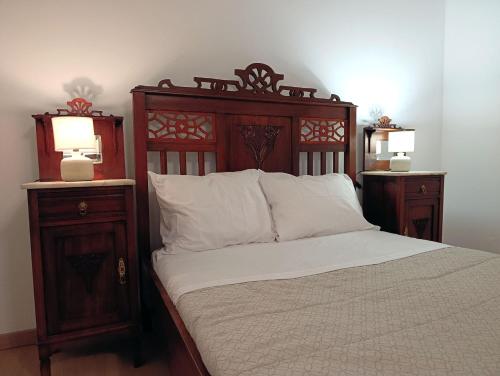 a bedroom with a bed with two night stands and two lamps at Casa da Volta - Porto Moniz in Porto Moniz