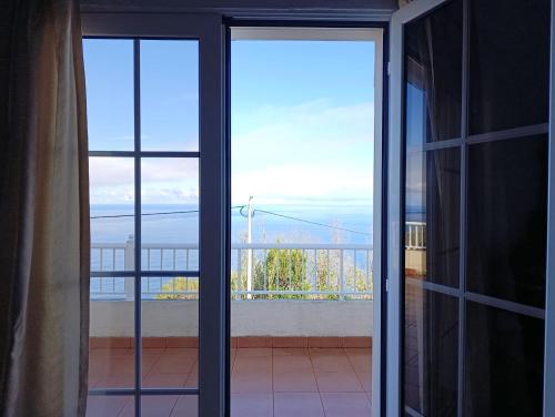 an open door to a balcony with a view at Casa da Volta - Porto Moniz in Porto Moniz