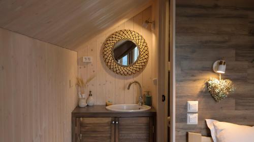 a bathroom with a sink and a mirror on the wall at Aglamp Almaty in Besqaynar