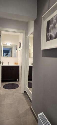a bathroom with a sink and a mirror on a wall at Casa Arena 2 in Nigrán