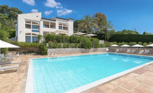 a swimming pool in front of a villa at Villa Saint Maxime in Saint Paul de Vence