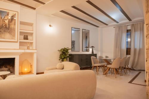 a living room with a couch and a fireplace at Boutique Casa de los Pedraza in Baeza