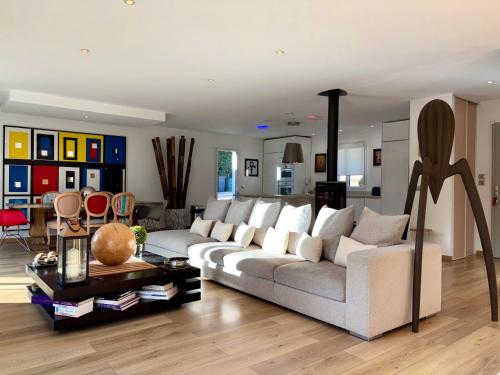 a living room with a couch and a table at Villa Grey - Brignoles - Provence verte in Brignoles