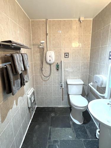 a bathroom with a shower and a toilet and a sink at The Old Inn in Gairloch