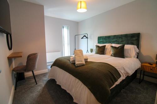 a bedroom with a large bed and a chair at Restful Riverside Residence in Morton
