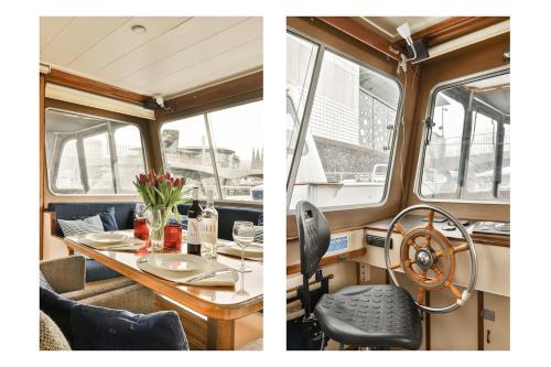 a dining table and chairs in a yacht at Authentic houseboat Amalia in Amsterdam